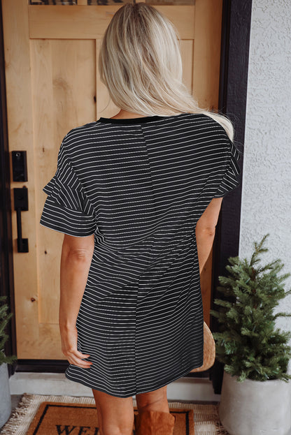 Woman wearing a black striped short-sleeve shift mini dress with ruffled sleeves