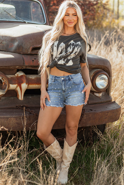 Bold, beaded, and beautifully distressed. These denim shorts are your go-to for effortless edge, featuring raw hems and delicate bead detailing that elevate any casual look.