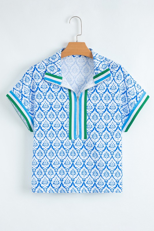 Intricate collar detail adds a touch of sophistication to the relaxed tunic style. 