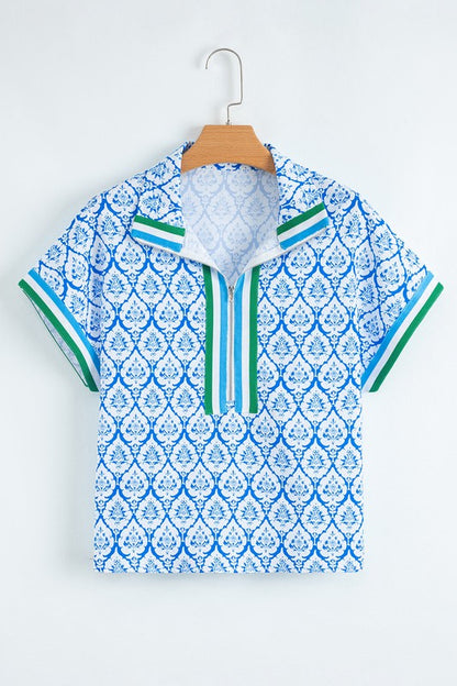 Intricate collar detail adds a touch of sophistication to the relaxed tunic style. 