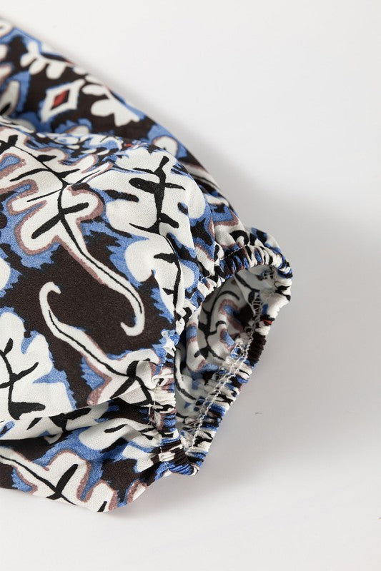 Frilled neckline with lace-up detail offers a feminine and adjustable look. 