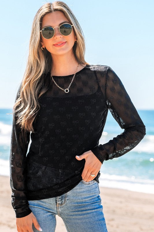 Sheer mesh top detailed with delicate bow accents for a playful, elegant look.