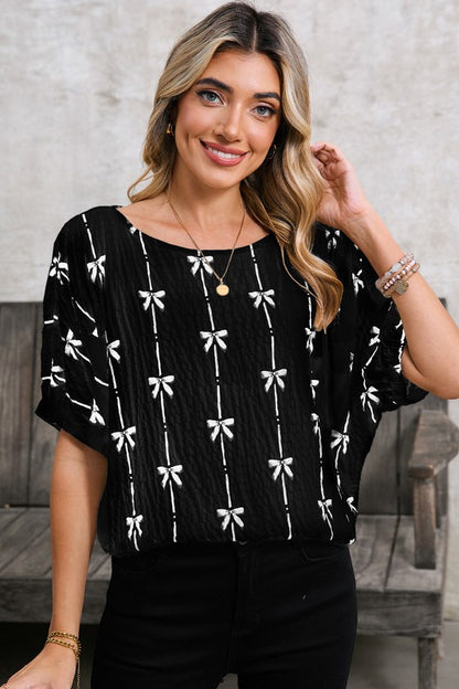 Puff short sleeves for a trendy, feminine look. Bow Print Puff Top colour black
