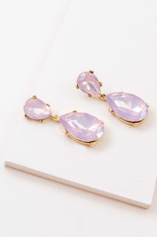 The Briel Drop Earrings in Pink Crystal are designed to add a touch of romance and radiance to any look. With faceted pink stones that catch the light and a sleek drop silhouette, these earrings are perfect for weddings, date nights, or everyday elegance.