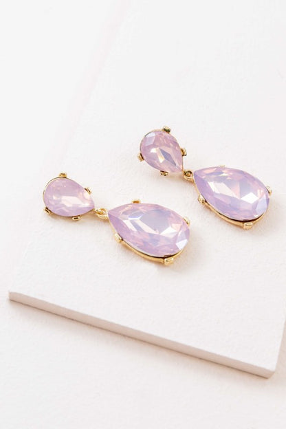 The Briel Drop Earrings in Pink Crystal are designed to add a touch of romance and radiance to any look. With faceted pink stones that catch the light and a sleek drop silhouette, these earrings are perfect for weddings, date nights, or everyday elegance.