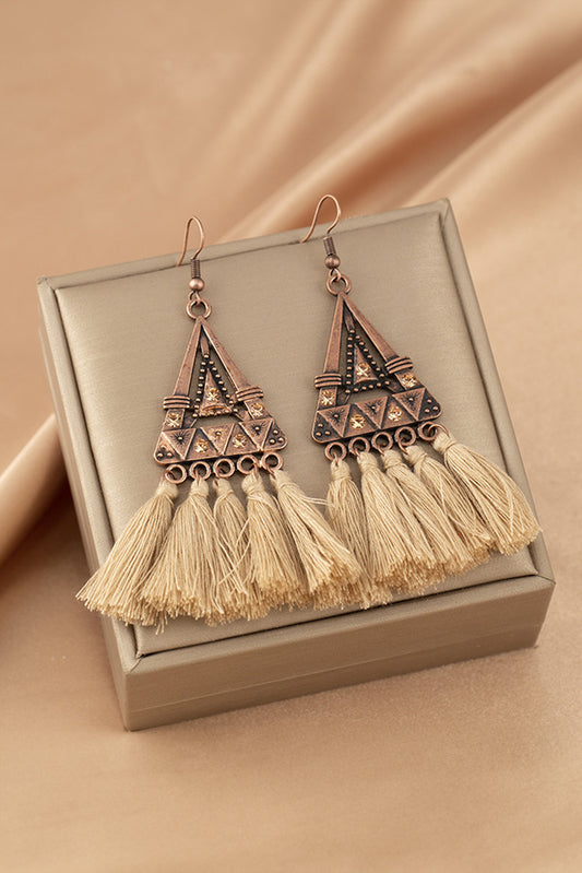 Boho soul, statement style. These earrings are a love letter to laid-back elegance. Featuring a geometric triangle frame in warm-toned metal, finished with cascading brown tassels, they bring movement, texture, and a touch of wanderlust to any outfit.