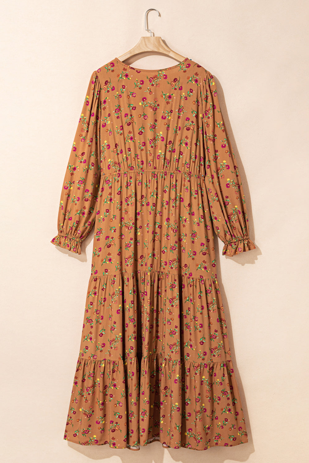 A plus size floral maxi dress with split V-neck and tiered design.