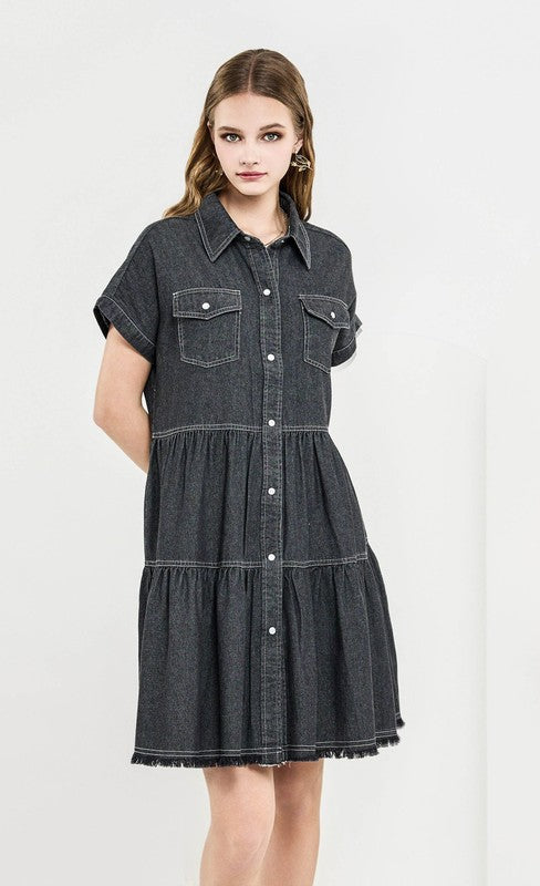 Woman wearing a black denim dress on a white background