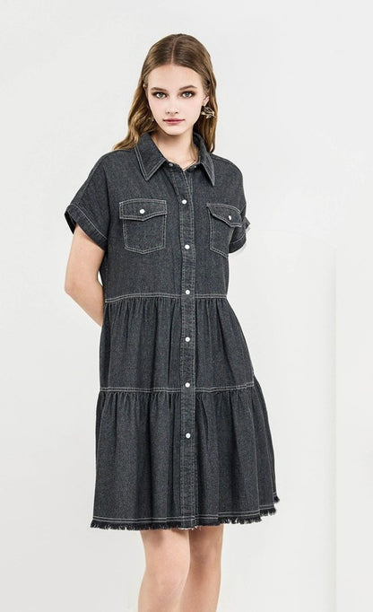 Woman wearing a black denim dress on a white background