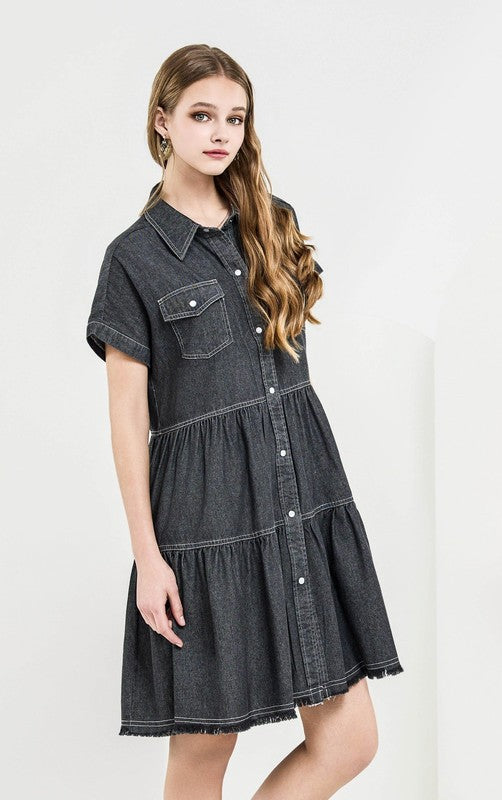 Woman wearing a black denim dress on a white background