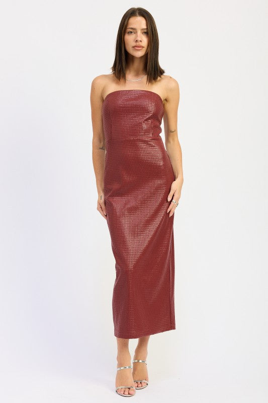 A woman models a sleek, strapless midi dress with a textured finish, ideal for a chic evening look.