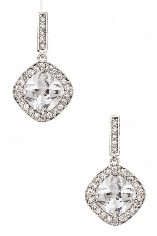 A pair of rose gold dangle earrings with a big clear gemstone in the middle, surrounded by smaller sparkly stones. Got a cute diamond-shaped design.