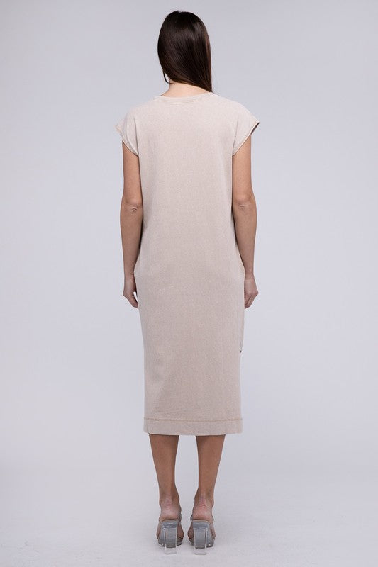 Woman models a comfortable midi dress with a relaxed fit and convenient side pockets, back view.