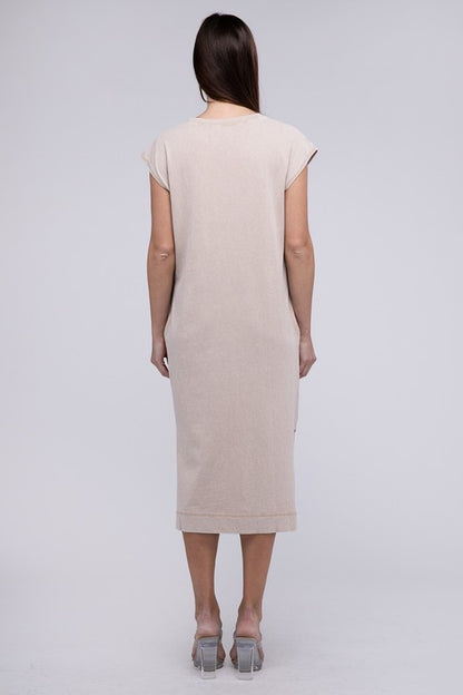 Woman models a comfortable midi dress with a relaxed fit and convenient side pockets, back view.