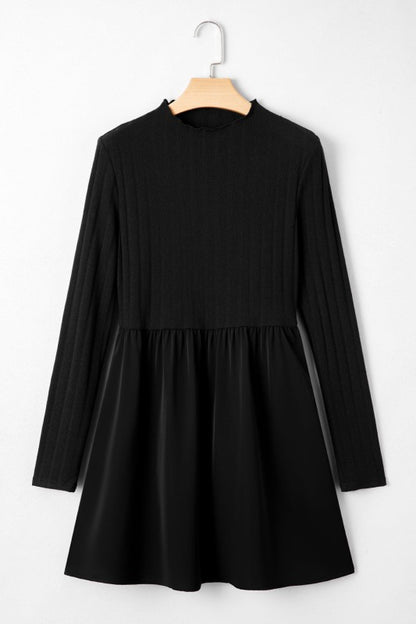 A black casual ribbed knit long sleeve dress in a white background. 