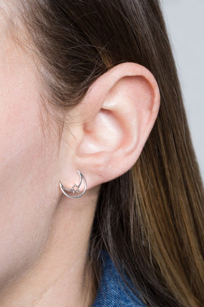 Moonlight meets starlight. The Celestial Unity Earrings in Silver celebrate harmony between cosmic forces. Featuring delicate moon and star motifs in a sleek silver finish, these earrings are perfect for dreamers, stargazers, and anyone drawn to the magic of the night sky.