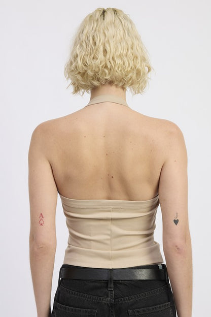Hits around the waist or just below — great paired with high-rise jeans or skirts. (Common for halter knits)