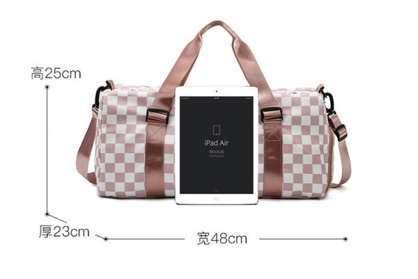 Checkered print duffel bag with a shoulder strap and top handles, ideal for gym or travel.