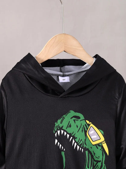 Black hoodie with a green dinosaur graphic on a hanger against a gray background