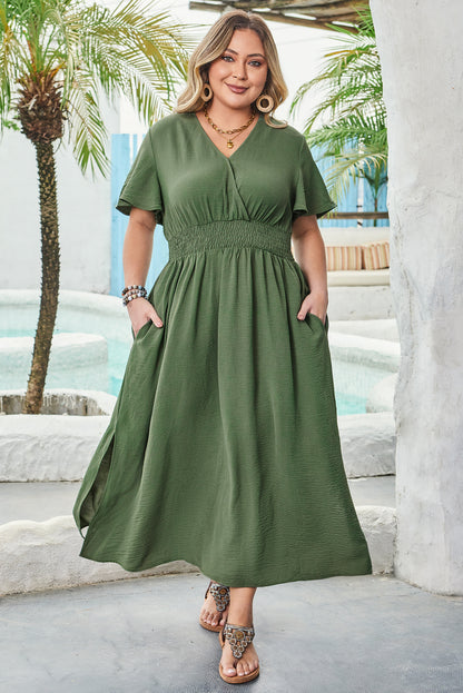 Chic plus size maxi dress in olive green featuring a surplice V-neckline, shirred high waist, short sleeves, and side slit. Comfortable and flattering fit.