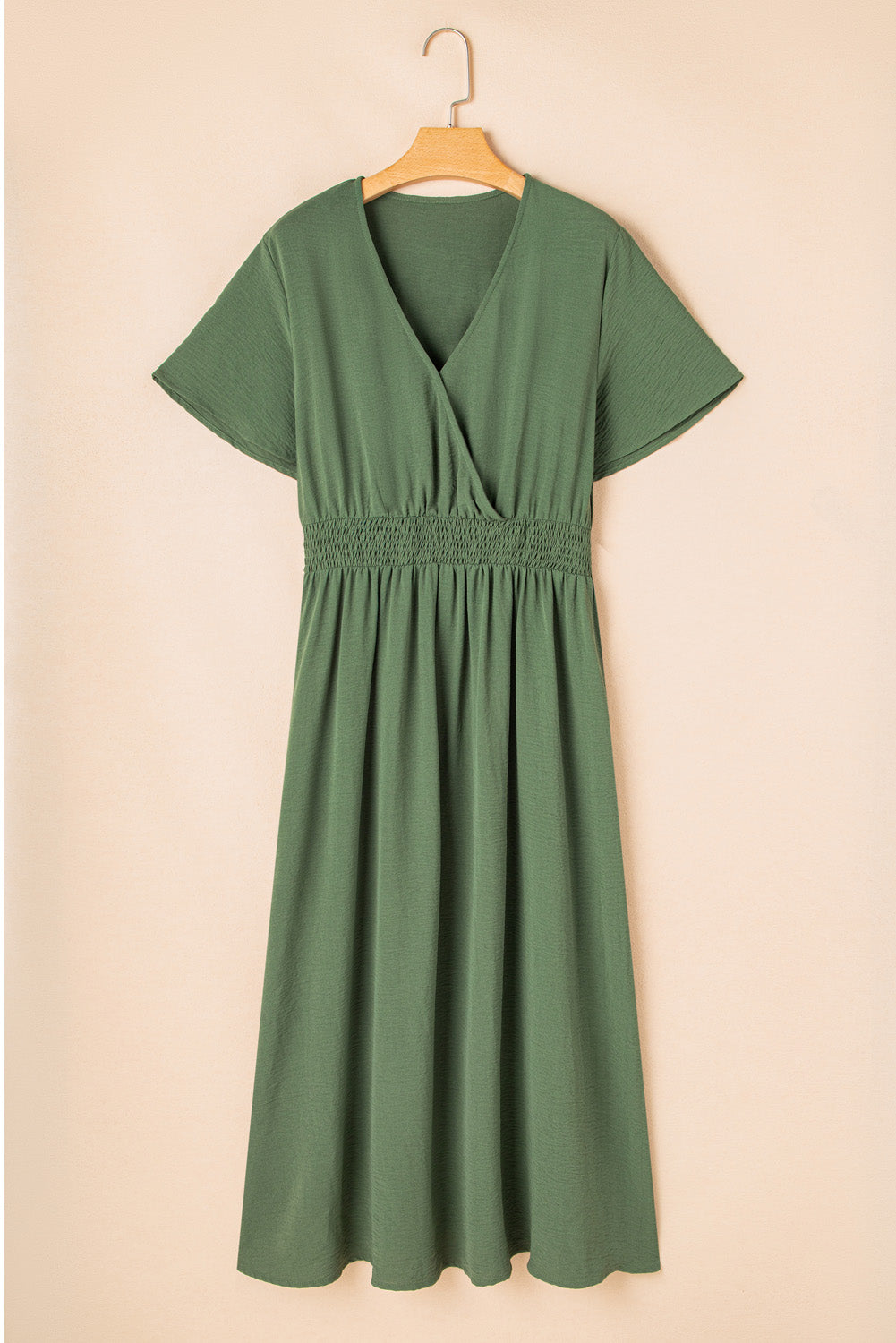 Chic plus size maxi dress in olive green featuring a surplice V-neckline, shirred high waist, short sleeves, and side slit. Comfortable and flattering fit.