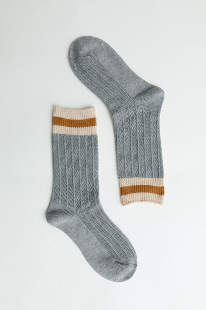 Grey ribbed crew socks with striped cuffs for comfortable use.