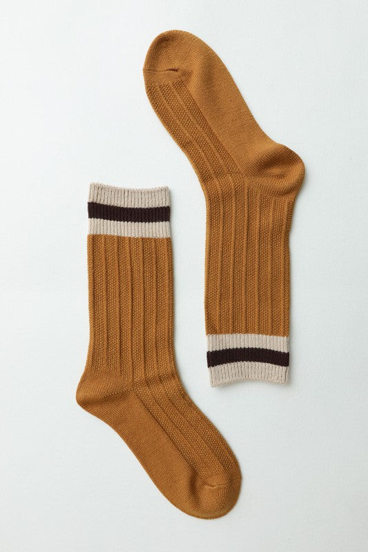 Mustard ribbed crew socks with striped cuffs.