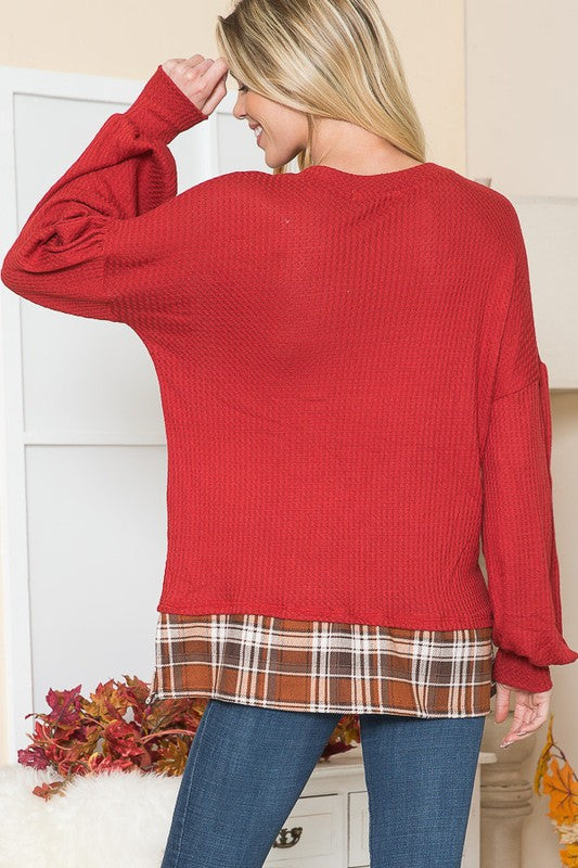 Balloon sleeves and plaid accents bring a playful edge to a classic silhouette.