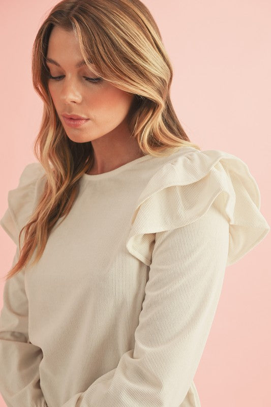 Feminine ruffled flounce sleeves add playful charm.