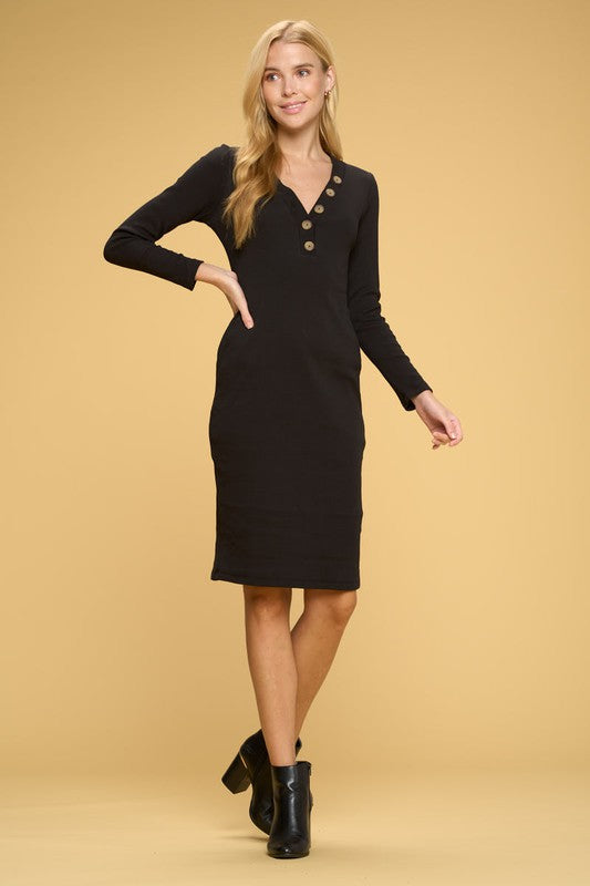 Woman wearing a black dress with buttons on a beige background