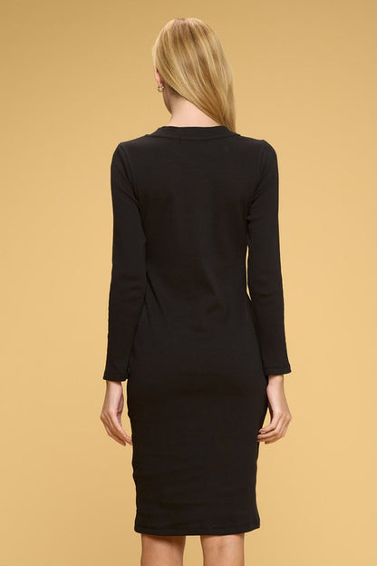 Black dress worn by a person on a beige background