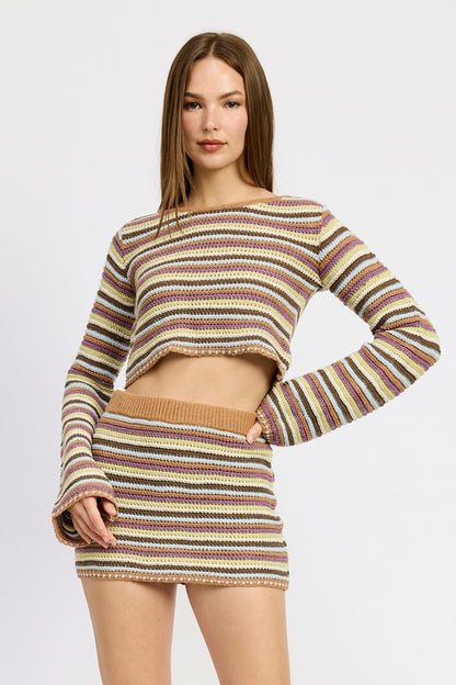 Soft crochet knit with a round neck and dramatic bell sleeves for a boho flair.