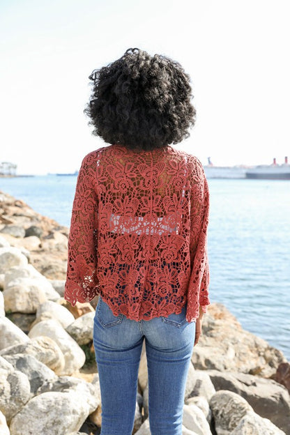 The petal crochet detail frames the silhouette with delicate artistry.