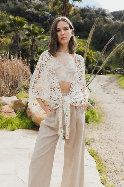 Open-front kimono with crochet floral petal details for a soft boho vibe.