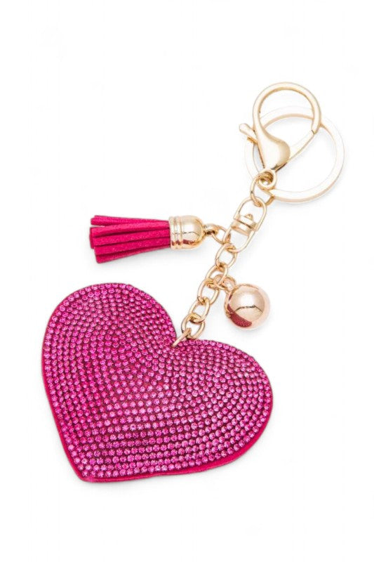 Heart-shaped pink rhinestone keychain with gold hardware, featuring a matching tassel and charm, glamorous, playful, and perfect for accessorizing bags or keys.