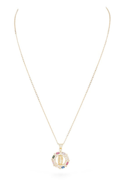 Gold necklace with a pendant. The pendant is circular with a gold Virgin Mary figure in the center. It's surrounded by a ring of clear and colored gemstones (pink, green, blue, peach). The background is white with a black border. 