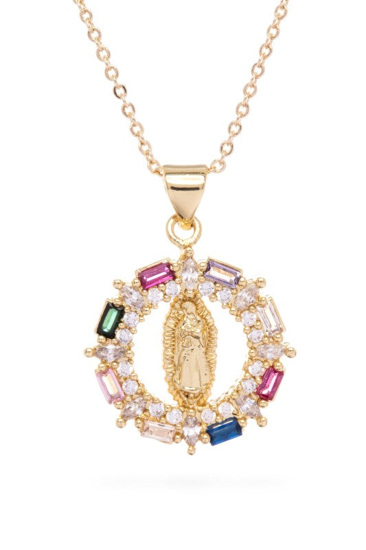Gold necklace with a pendant. The pendant is circular with a gold Virgin Mary figure in the center. It's surrounded by a ring of clear and colored gemstones (pink, green, blue, peach). The background is white with a black border. 