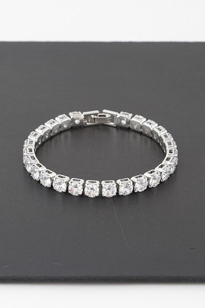 Silver tennis bracelet adorned with round-cut clear gemstones, set in a continuous row for an elegant and classic look.