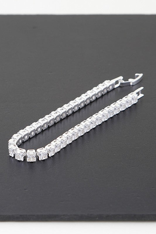 Silver tennis bracelet adorned with round-cut clear gemstones, set in a continuous row for an elegant and classic look.