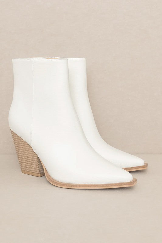 Off-white leather ankle booties featuring pointed toe, textured wood-look block heel, and tan sole trim.