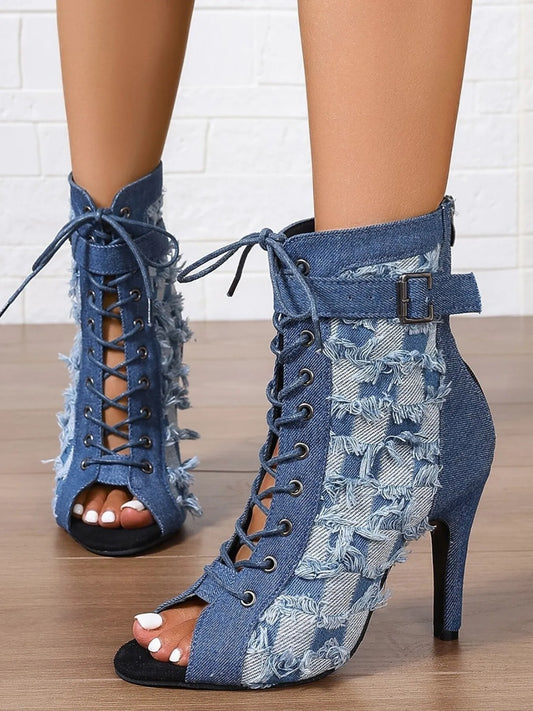 Denim peep-toe ankle booties with lace-up front, distressed frayed edges, ankle strap buckle, and stiletto heel
