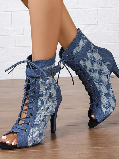 Denim peep-toe ankle booties with lace-up front, distressed frayed edges, ankle strap buckle, and stiletto heel