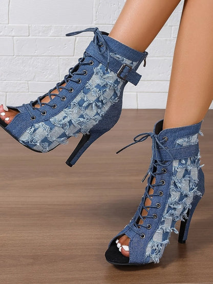 Denim peep-toe ankle booties with lace-up front, distressed frayed edges, ankle strap buckle, and stiletto heel