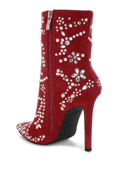 Red high-heeled boot with floral embellishments on a white background