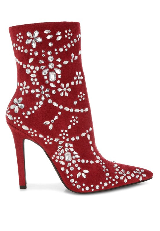 Red ankle boot with floral embellishments on a white background