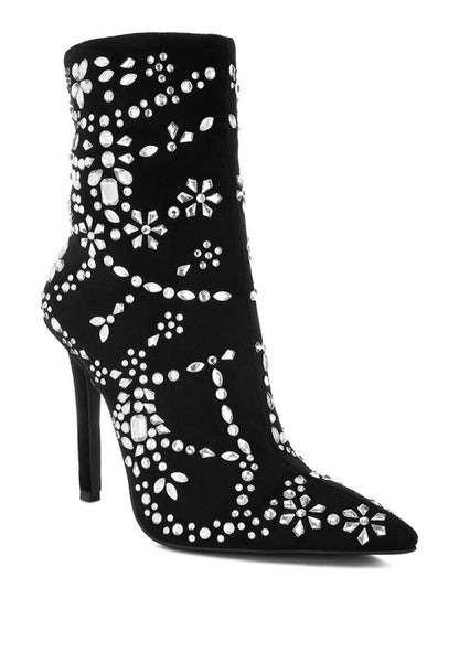 Black high-heeled boots with white floral patterns on a white background