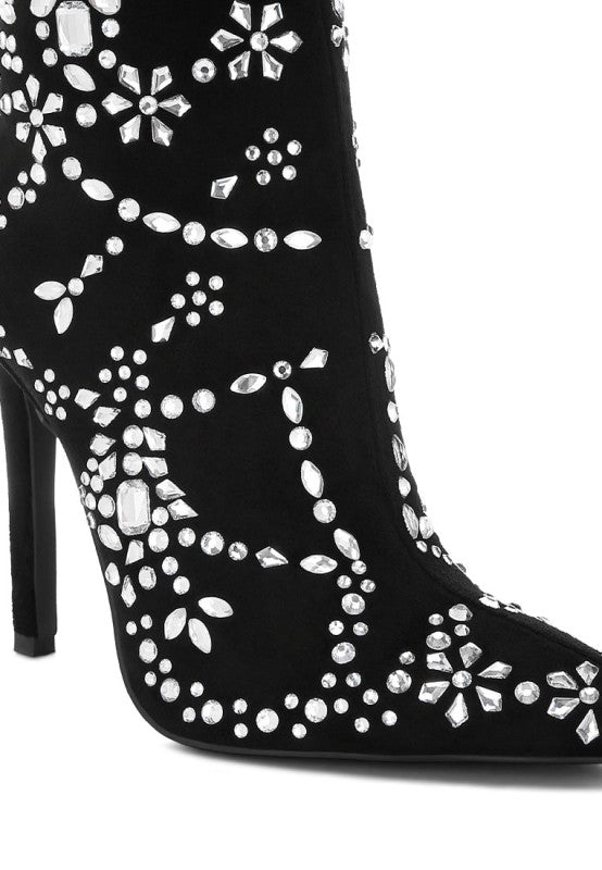 Black high-heeled boot with white floral and geometric patterns on a white background