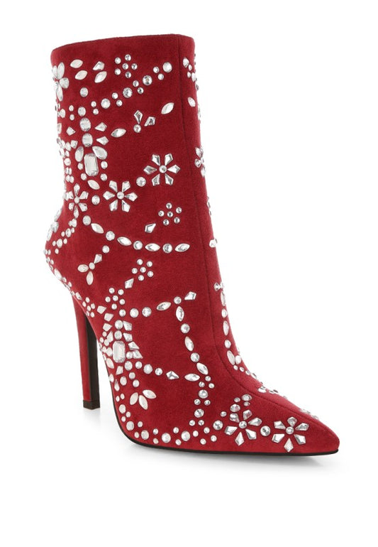 Red ankle boot with white floral embellishments on a white background