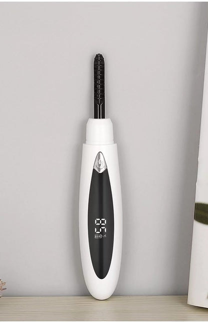 Electric eyelash curler with ergonomic design and USB charging port, ideal for achieving natural-looking curls.

