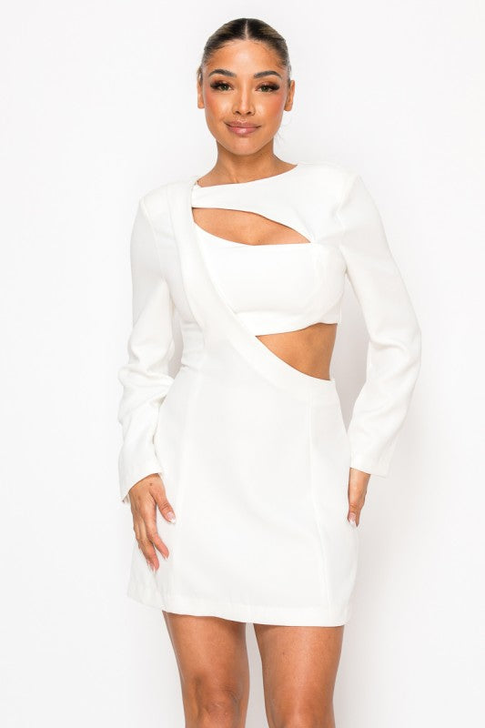 Woman wearing a long-sleeve mini dress with asymmetrical cutouts across the chest and midriff, styled against a plain white background.